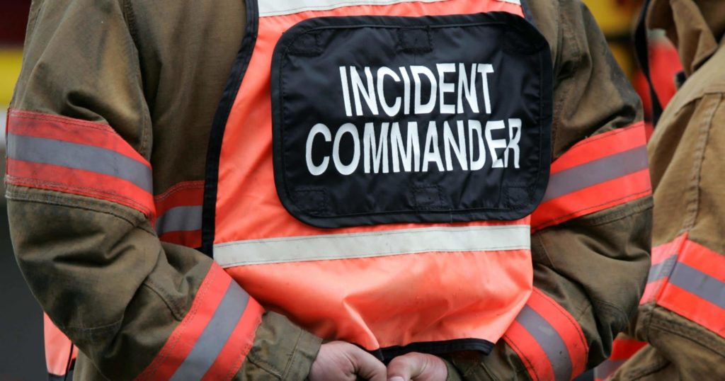 Incident Commander standing at the scene of an incident